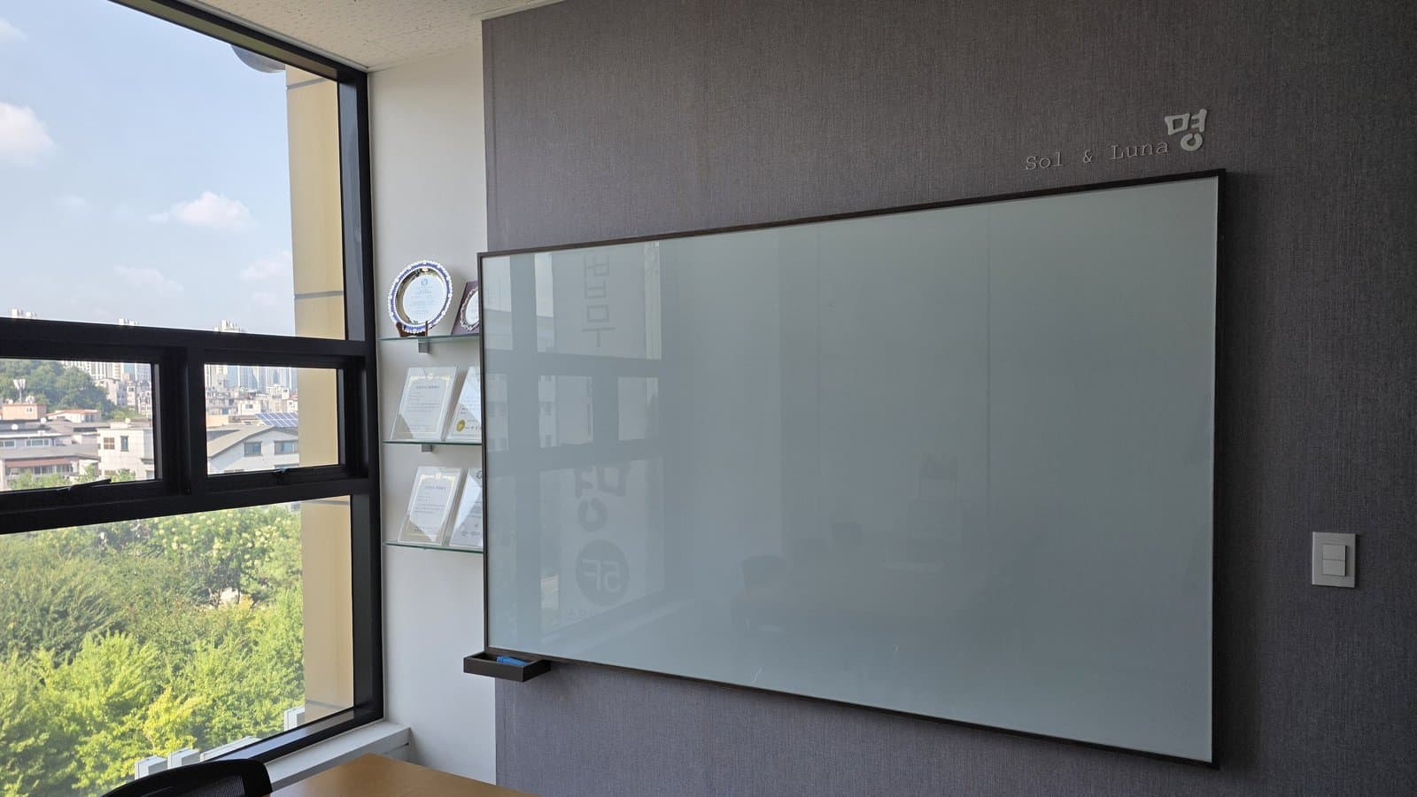 Consultation room wall with the Sol & Luna lettering at SOL & LUNA Law Firm